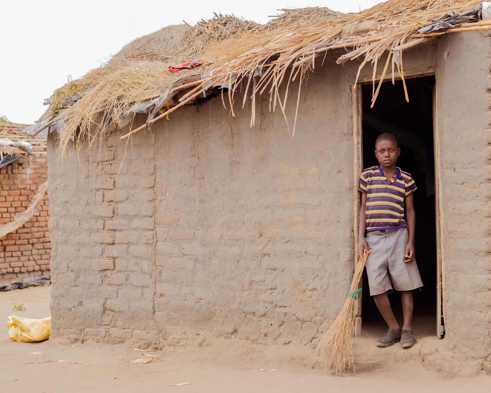 Thoko outside his home in a rural village in Lilongwe, Malawi.