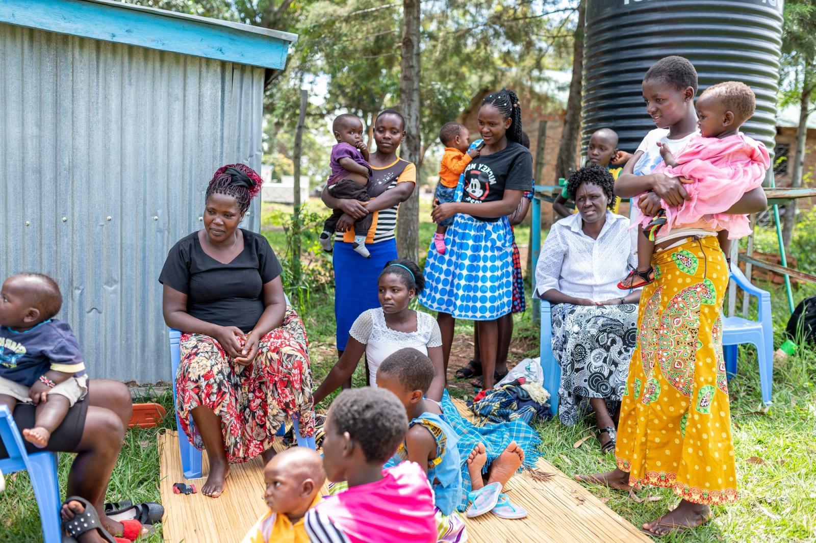 A group of women and children outside.