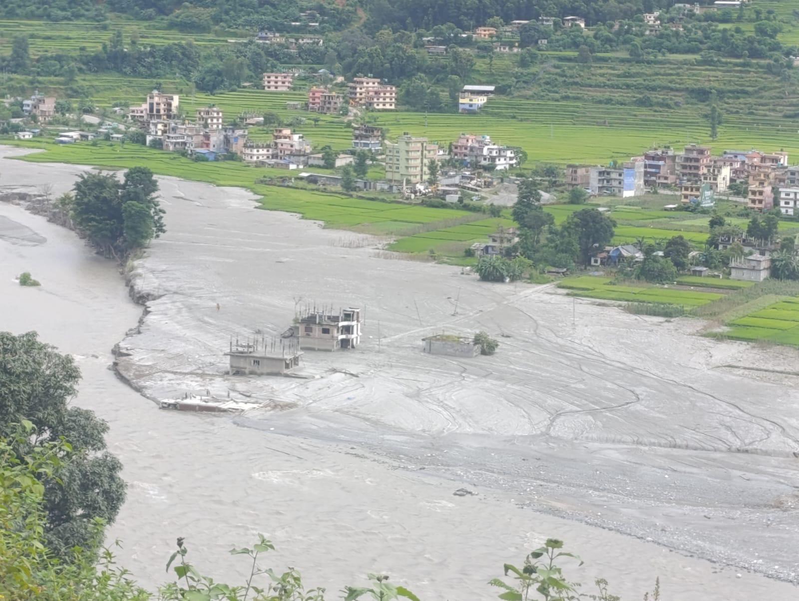 Buildings and land covered in mud and water after devastating floods in Nepal