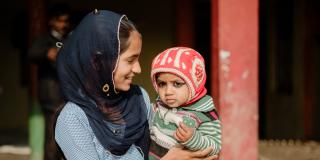 Young girl holding baby