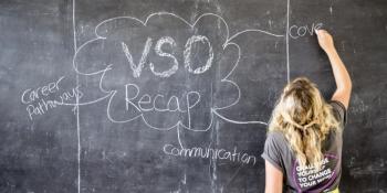 Volunteer writes on blackboard