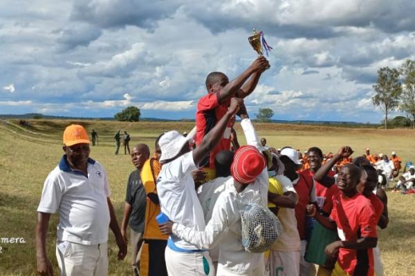 Prison inmates celebrate a football win