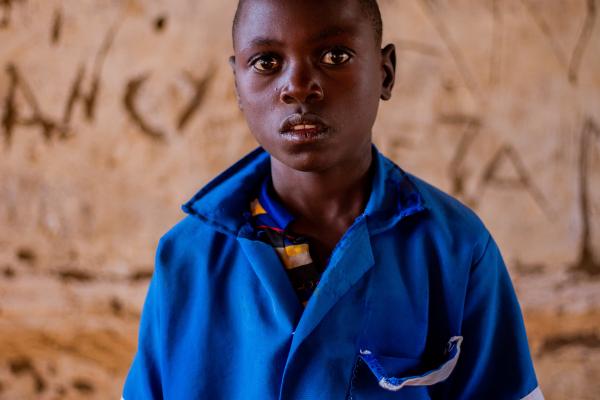 Thoko stood in an empty classroom in his school.