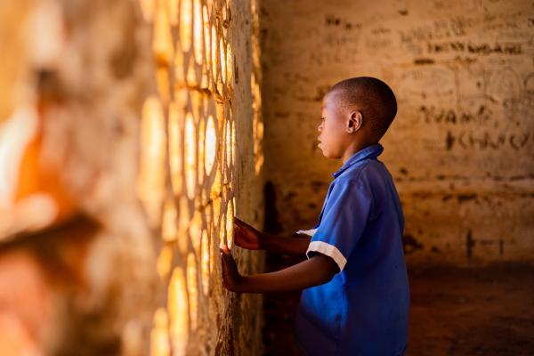 Thoko stood in an empty classroom in his school.