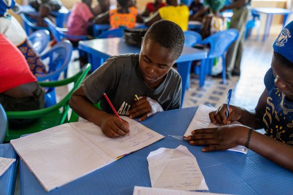 Girl writing in a notebook in a classroom