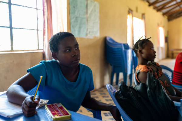 Girl wearing a blue t-shirt in classroom in Kenya