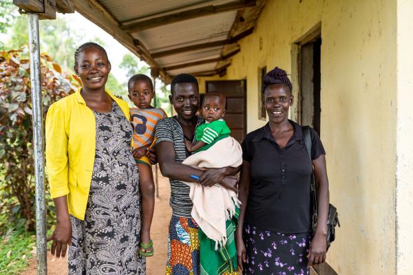 Three women and two babies standing outside