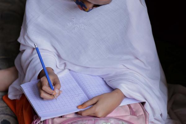 Najeeba writing on her notebook