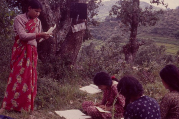 Students learn on the floor, 1980s Nepal