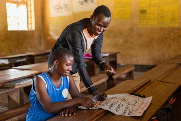 Juliet engaging in a science activity with her teacher Samuel.