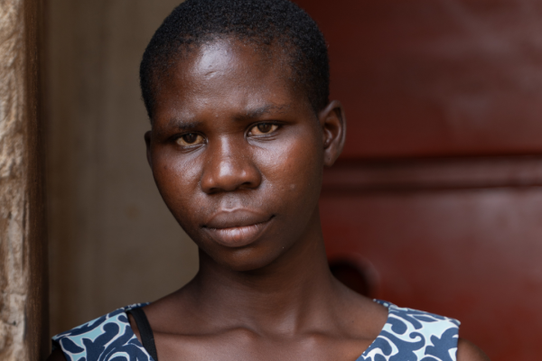 Juliet stands outside her home.
