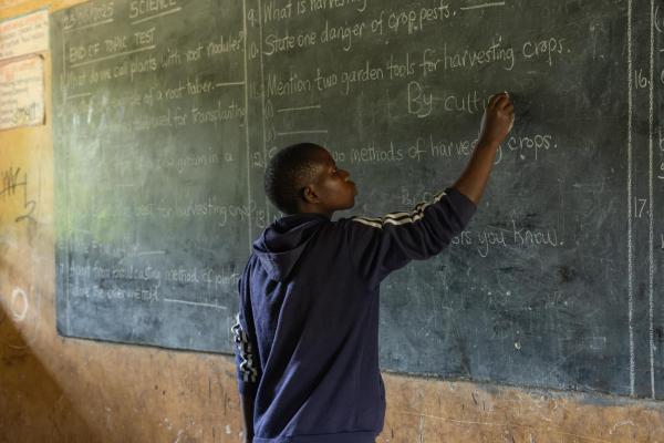 Juliet writing on the blackboard.