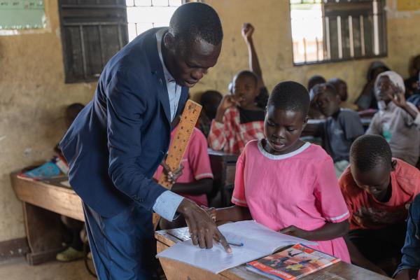 Nangiro gets help in the classroom from her teacher Denis