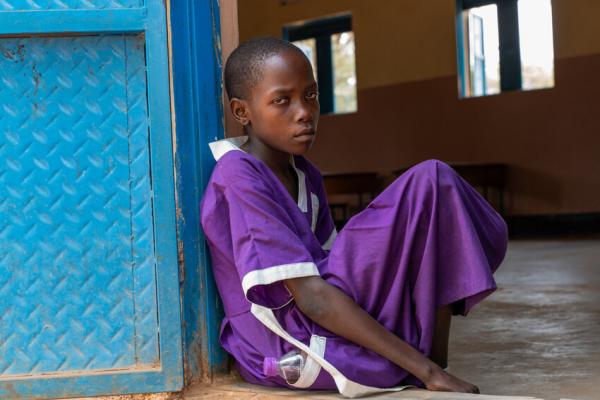 Nakiru sat outside a classroom