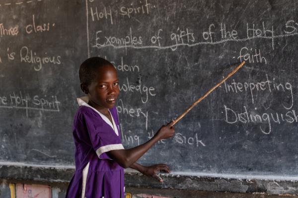 Nakiru stands at the front of the class