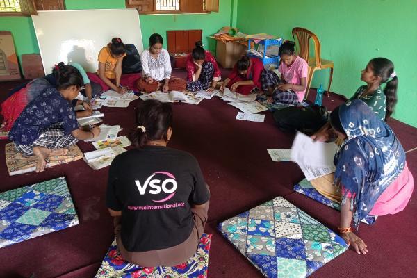 Women sitting in a circle in discussion in Nepal